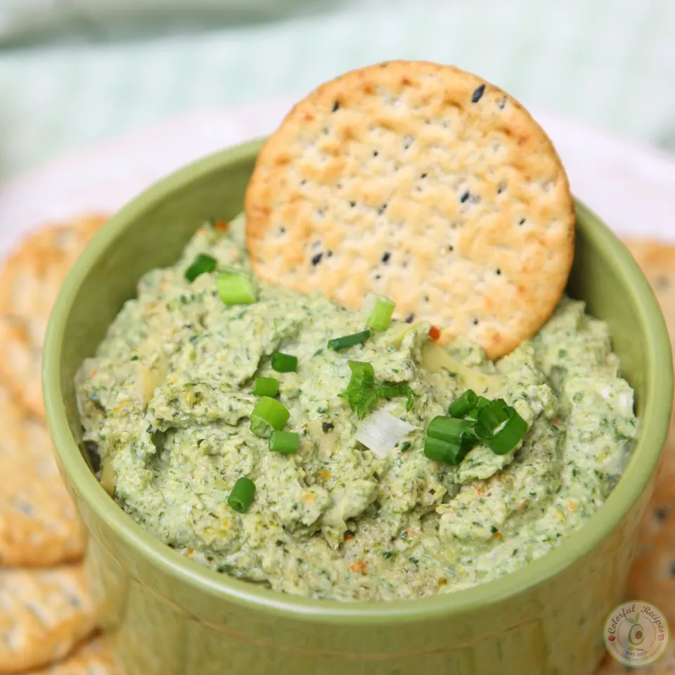 Hearty artichoke spinach dip garnished with green onions