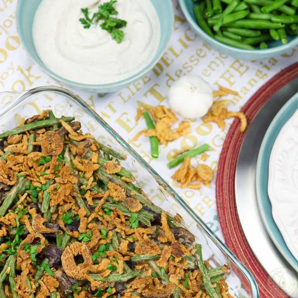 Baking dish of cashew cream green bean casserole with cashew cream and fresh green beans