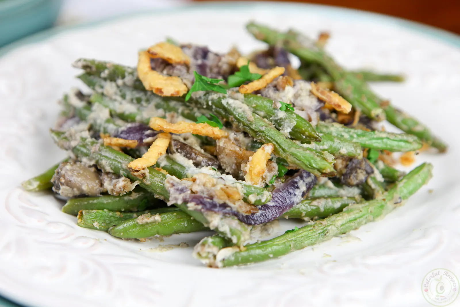 Serving of cashew cream green bean casserole with mushrooms and crispy onions
