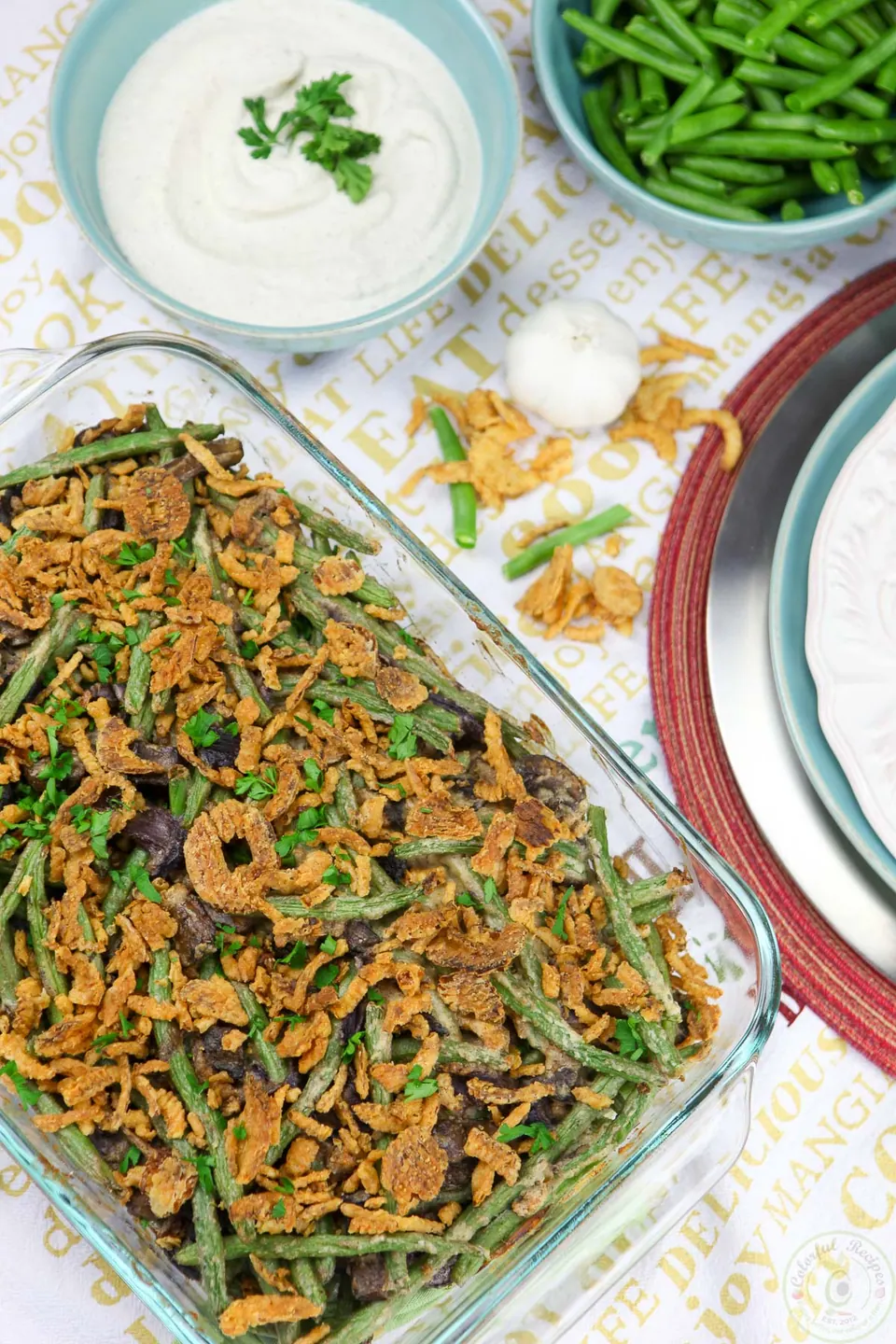 Cashew cream green bean casserole topped with crispy onions in a baking dish