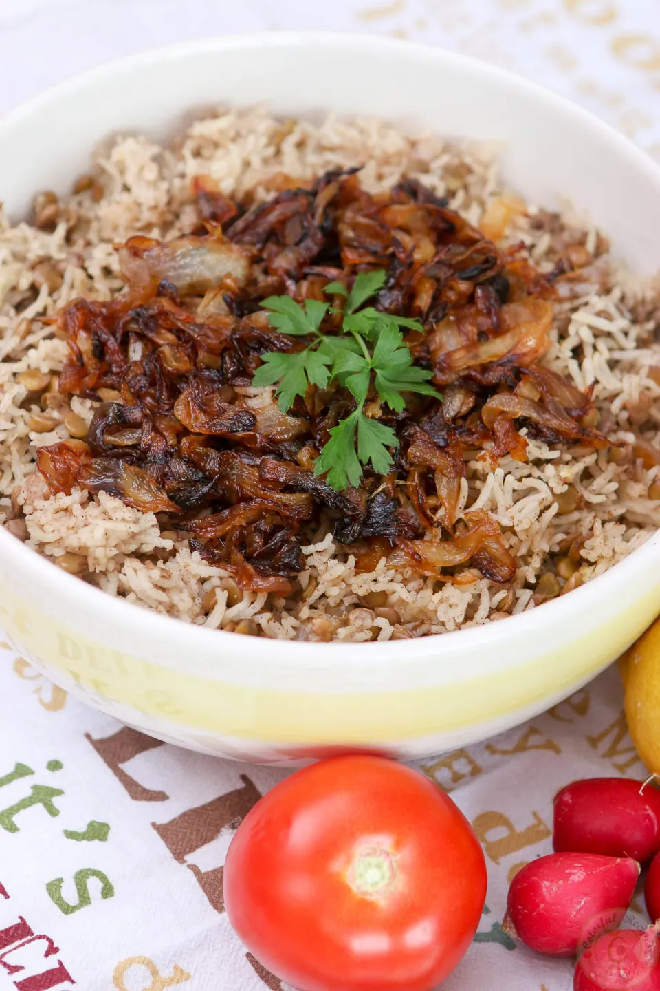Caramelized onion wedges on top of Lebanese lentil rice pilaf